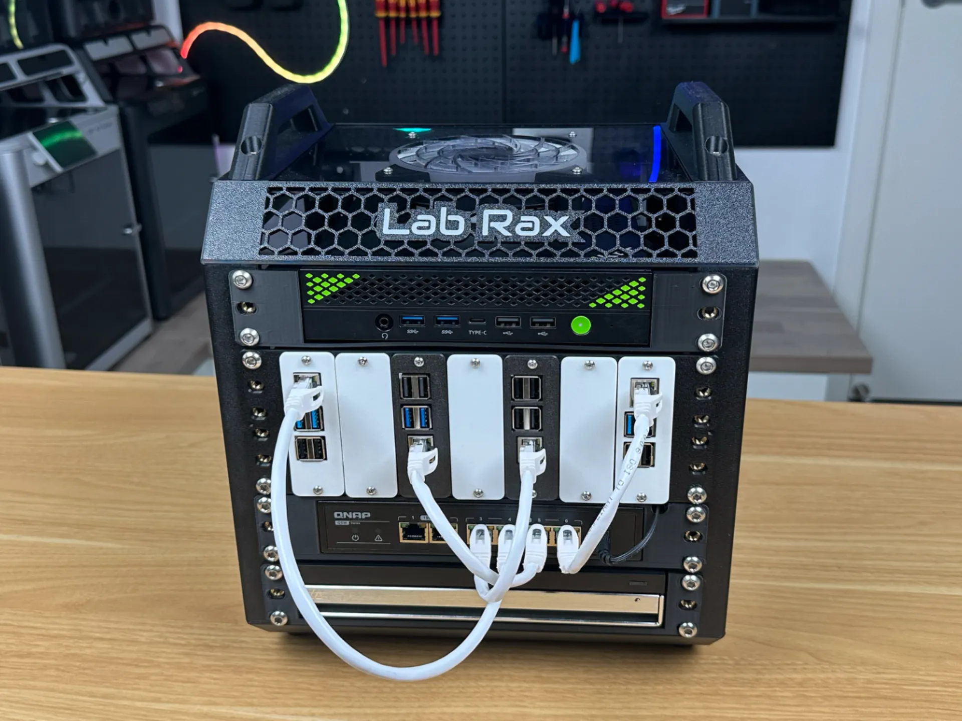 3D-printed 5U mini server rack housing a network switch and single-board computers with patch cables